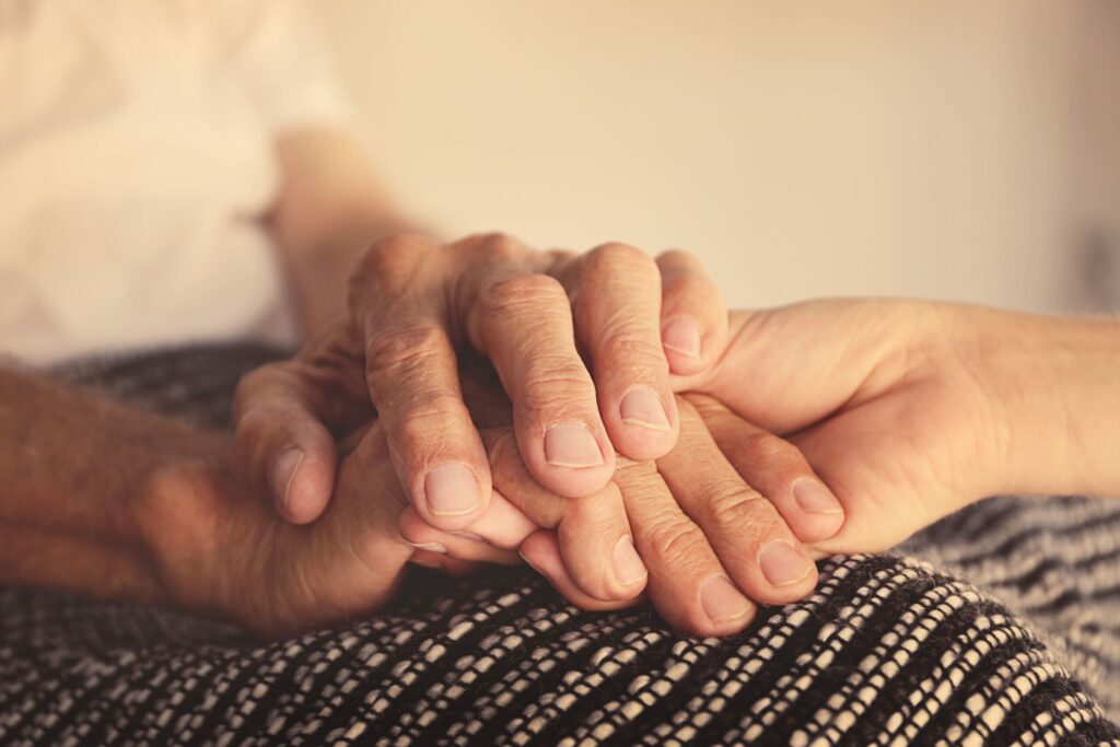 close up of holding hands with elderly